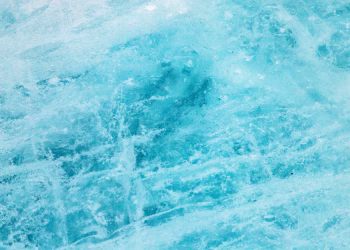 A close-up of pristine blue ice showcasing its natural crystalline texture and chilly ambiance.