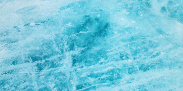 A close-up of pristine blue ice showcasing its natural crystalline texture and chilly ambiance.
