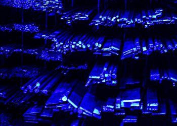 Rows of metal bars illuminated with blue light