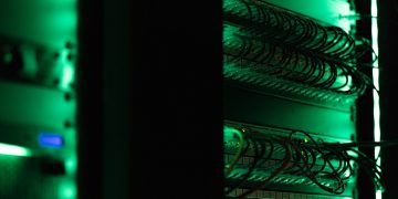 a rack of electronic equipment in a dark room