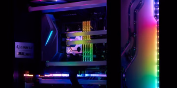 A high-performance gaming PC with vibrant RGB lighting and visible internal components.