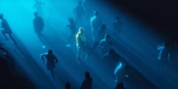 Surreal urban crowd scene with dramatic lighting focusing on a solitary figure.