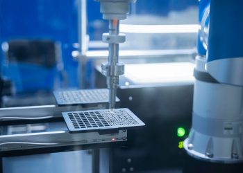 Close-up of robotic arm automating lab processes with precision.