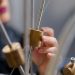 A student conducting an interactive physics experiment with brass components.