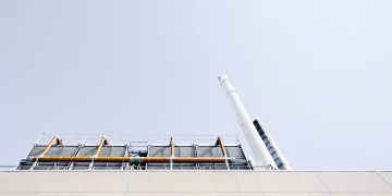 A modern power plant exterior with smokestacks under a clear sky in London, Ontario.