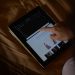 A woman browses an online shopping site on a tablet. Perfect for ecommerce and technology themes.