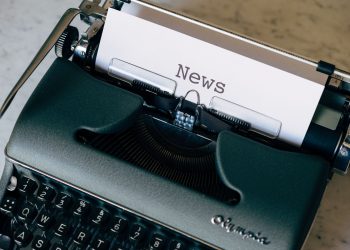 A vintage typewriter with a paper titled 'News', symbolizing journalism and communication.