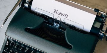 A vintage typewriter with a paper titled 'News', symbolizing journalism and communication.