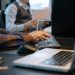 Close-up of office workers engaged in a tech project at a modern workplace.