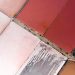 Vibrant aerial view of geometric salt ponds in varied red and pink hues.