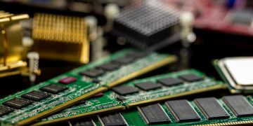 Detailed view of RAM sticks and microprocessors on a motherboard.