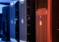 Close-up of tower servers in a data center with blue and red lighting.