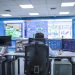 Operator in a modern control room managing technological systems in El Agustino, Lima.