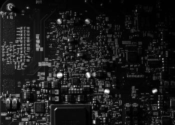 Detailed black and white photo of a circuit board showing intricate components, perfect for tech projects.