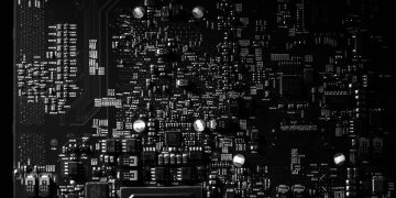 Detailed black and white photo of a circuit board showing intricate components, perfect for tech projects.