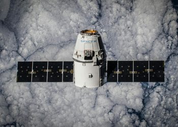 SpaceX Dragon spacecraft in orbit, highlighting advanced space technology with cloud backdrop.