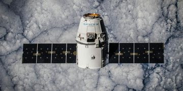 SpaceX Dragon spacecraft in orbit, highlighting advanced space technology with cloud backdrop.