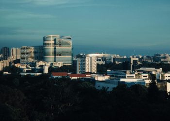 Skyline of Singapore featuring modern architecture under a clear blue sky.