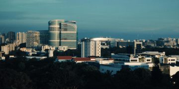 Skyline of Singapore featuring modern architecture under a clear blue sky.