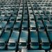 Overhead shot of a large collection of white pickup trucks parked in neat rows, emphasizing industrial scale.