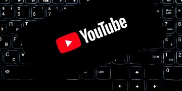 YouTube logo displayed on a backlit keyboard, representing digital media and online content creation.