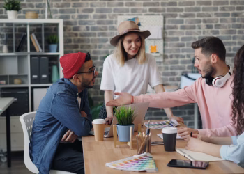 Group of young professionals brainstorming ideas in a modern office environment.
