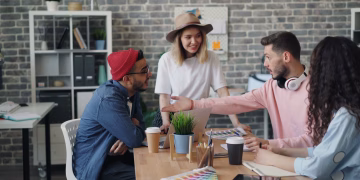 Group of young professionals brainstorming ideas in a modern office environment.