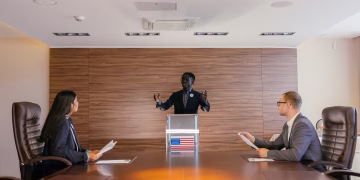 Three professionals deliberating in a modern conference room setting.