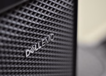 Detailed close-up of Dell EMC server logo on hardware grill with shallow focus and textured patterns.