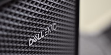 Detailed close-up of Dell EMC server logo on hardware grill with shallow focus and textured patterns.