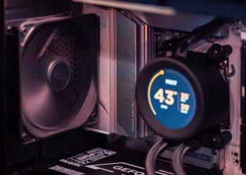 Close-up of a gaming PC build showcasing GPU, fan, and liquid cooling system.