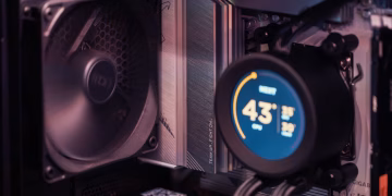 Close-up of a gaming PC build showcasing GPU, fan, and liquid cooling system.