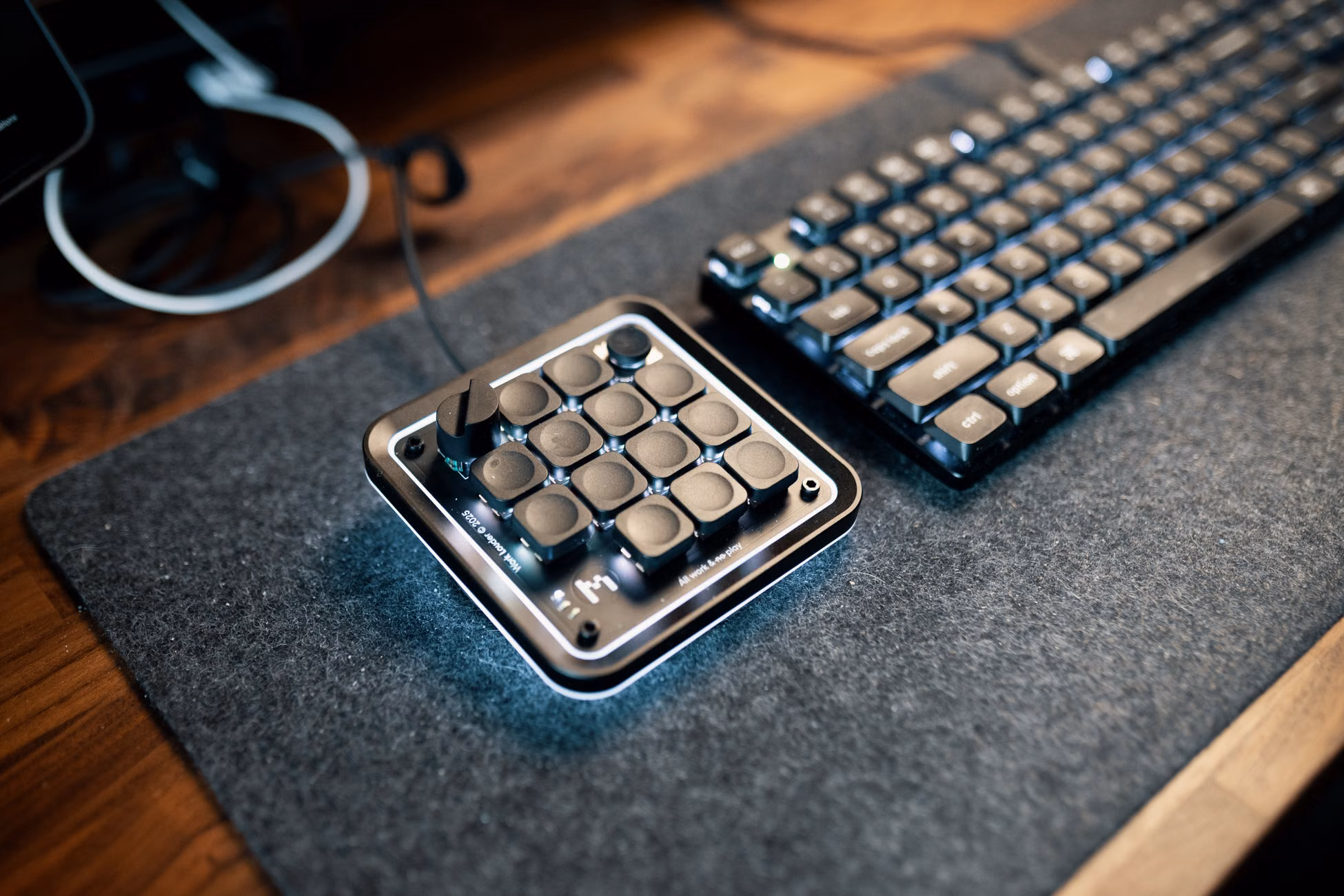 A minimalist desk featuring a macro keypad and mechanical keyboard for efficient computing.