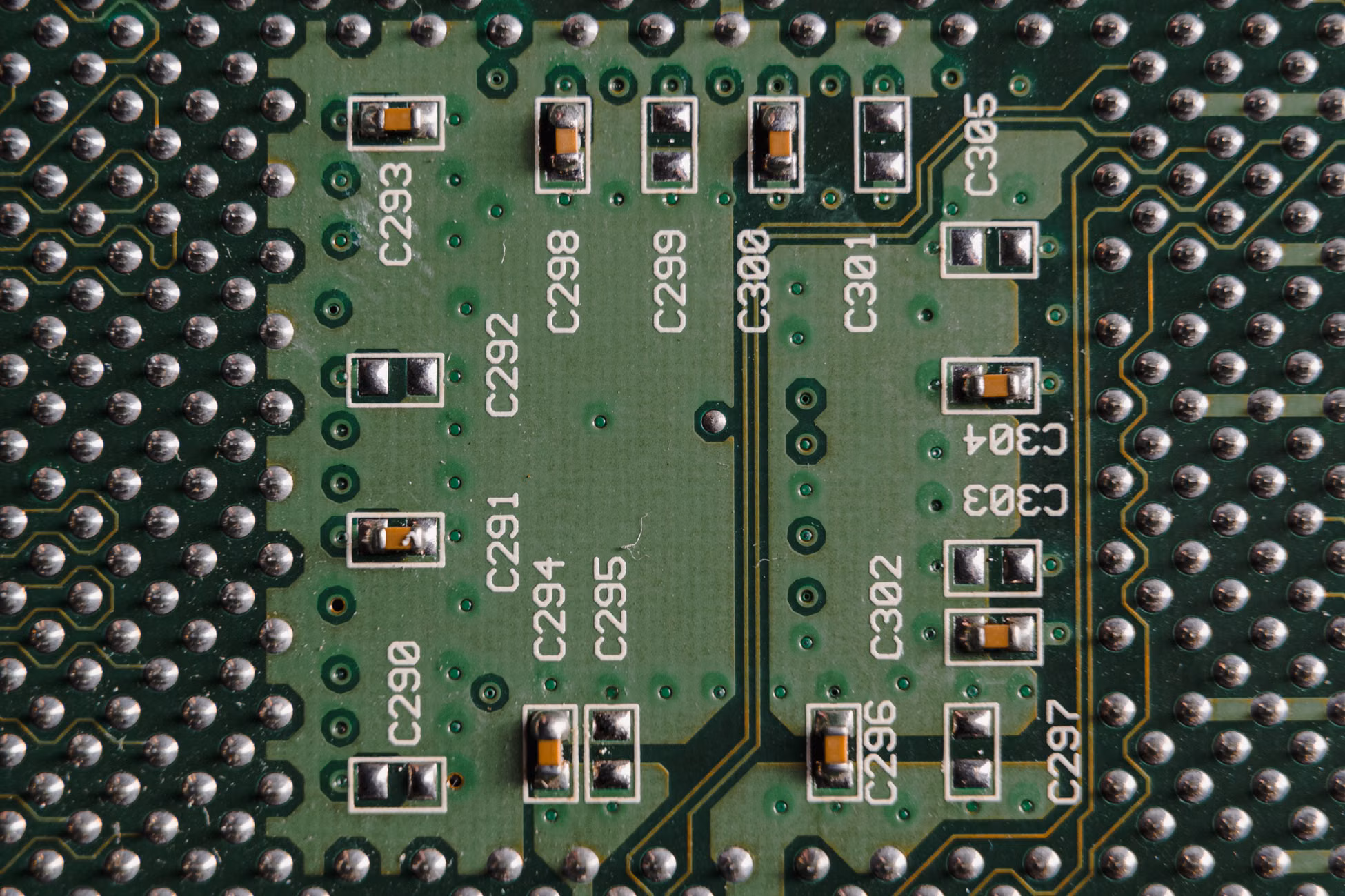Detailed close-up of a green circuit board featuring microchips and labeled components.