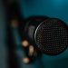 Detailed image of a black microphone with selective focus in a studio environment.