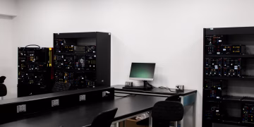 A contemporary electronics lab featuring workstations and technical equipment.