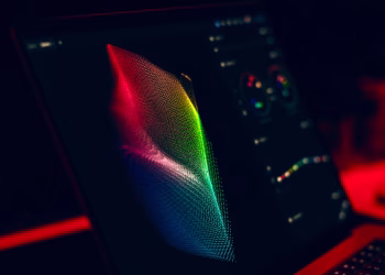 Close-up of vibrant digital art in red, green, and blue displayed on a monitor screen.