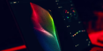 Close-up of vibrant digital art in red, green, and blue displayed on a monitor screen.