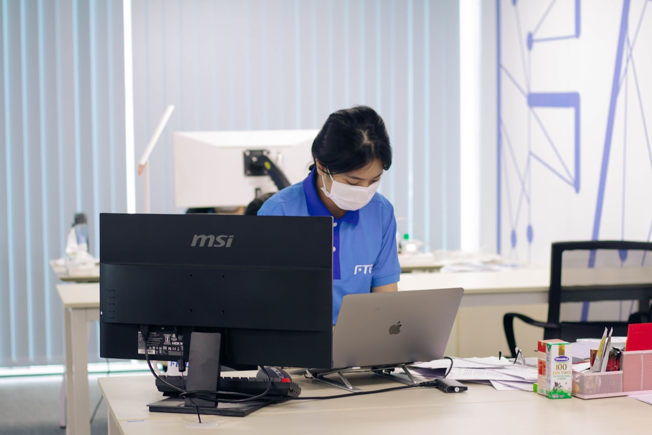 man in blue polo shirt using computer