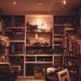 A warmly lit home library filled with a diverse collection of books and a cozy atmosphere.