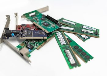 A detailed close-up of computer RAM sticks and PCI cards arr