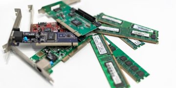 A detailed close-up of computer RAM sticks and PCI cards arr
