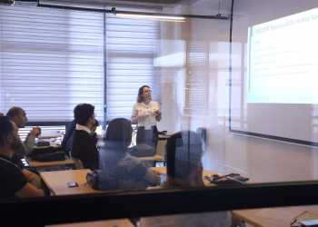 Audience attending a business presentation in a modern office environment.