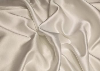 white textile on brown wooden table