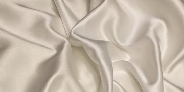 white textile on brown wooden table