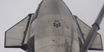 Detailed view of a space shuttle's bottom side showcasing its metallic surface and structure.