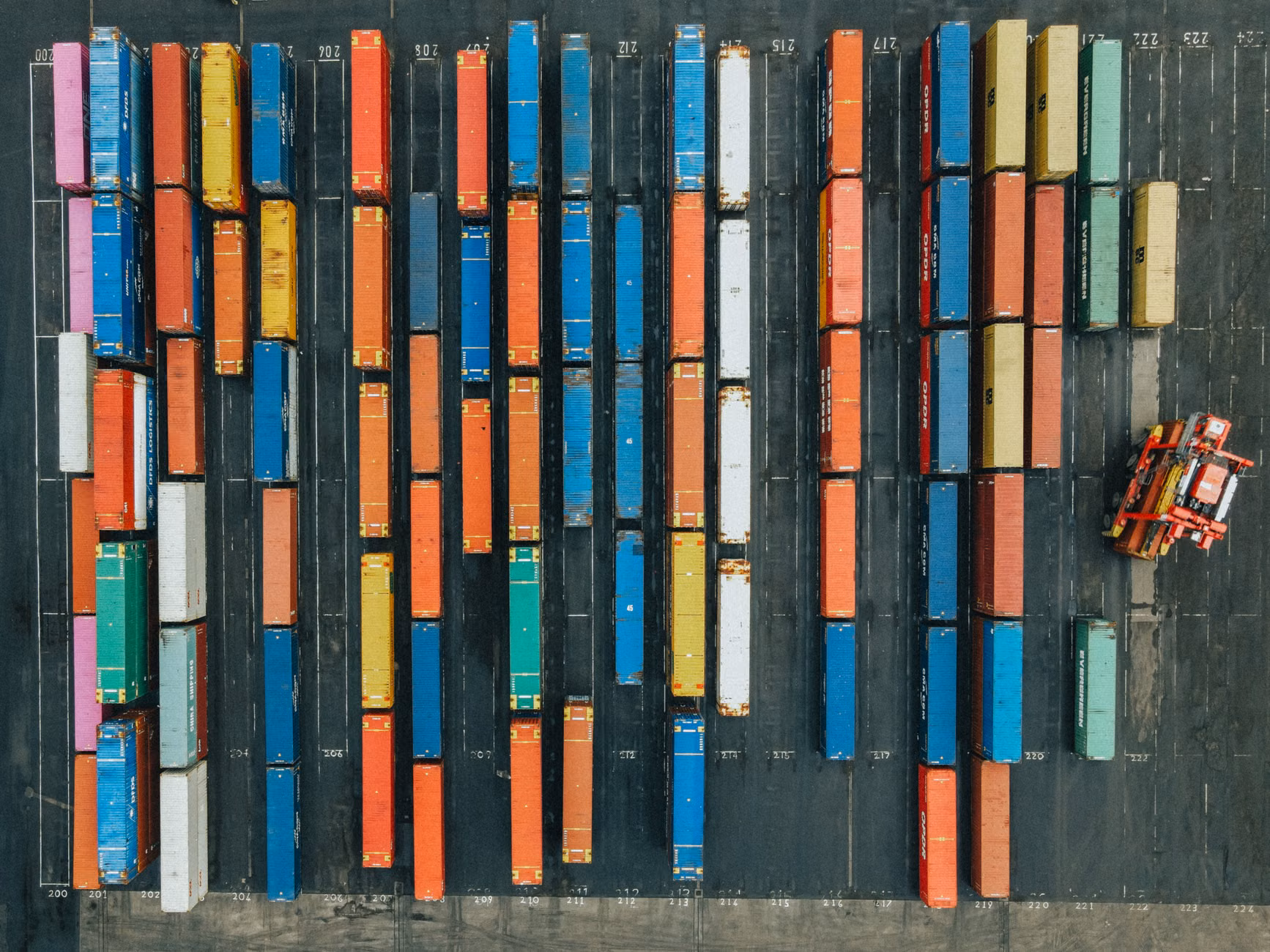 Aerial shot of colorful cargo containers in a logistics hub, Scotland.