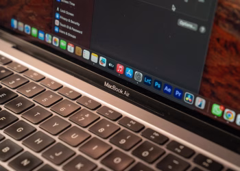 A detailed view of a MacBook Air with a focus on the keyboard and screen displaying app icons.