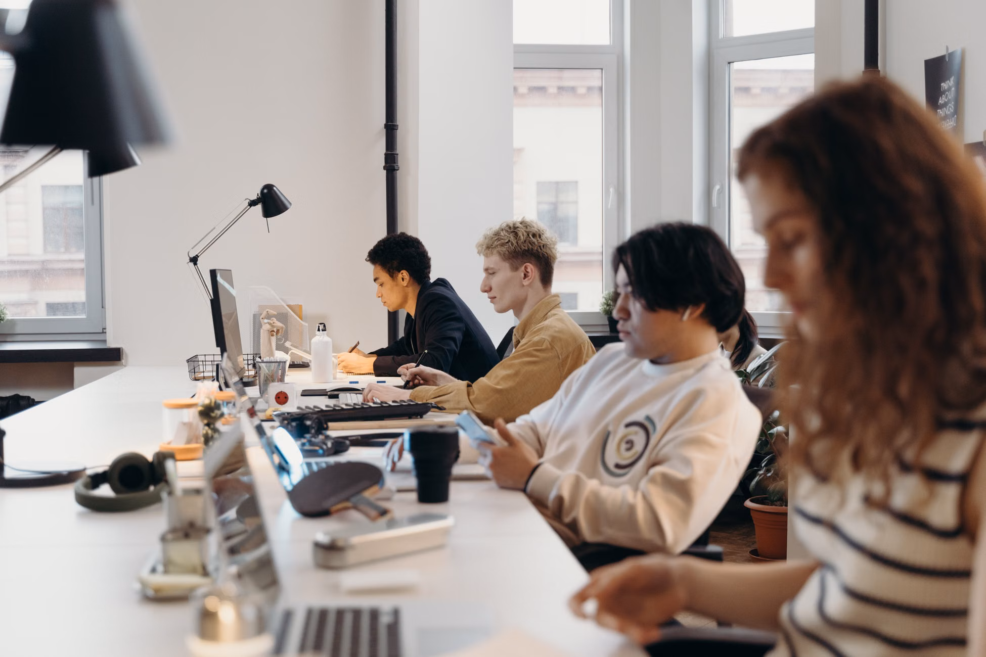 Young professionals working collaboratively in a modern office environment, fostering teamwork and innovation.