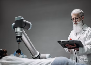 Senior scientist observing robot performing a task indoors.